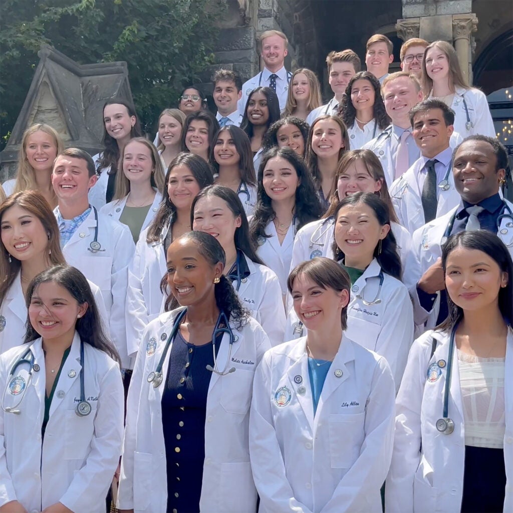 SMP alumni pose together on the steps of Healy Hall during the 2024 Georgetown School of Medicine White Coat Ceremony.